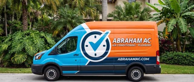 Abraham AC service van parked on pavement in front of tropical foliage